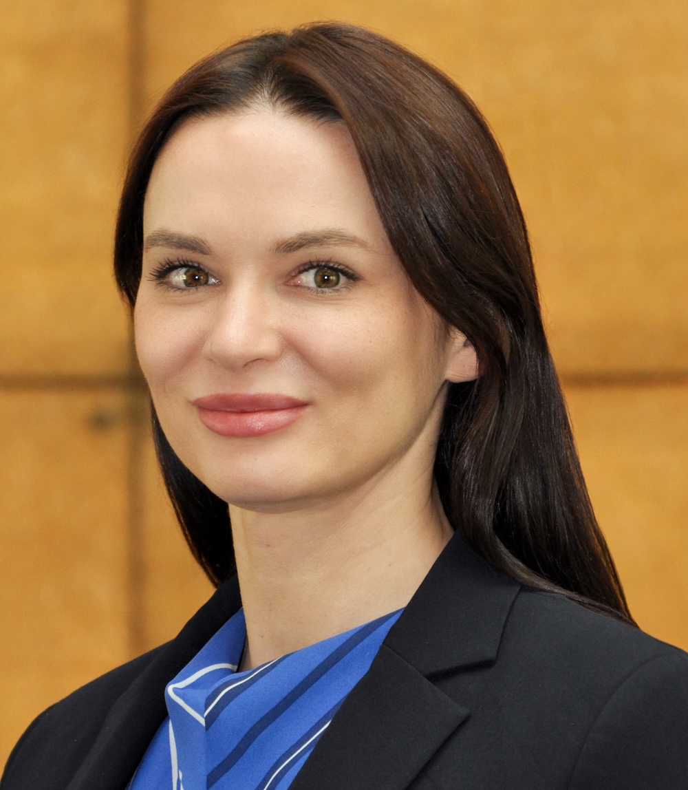 Dark haired woman smiling at camera