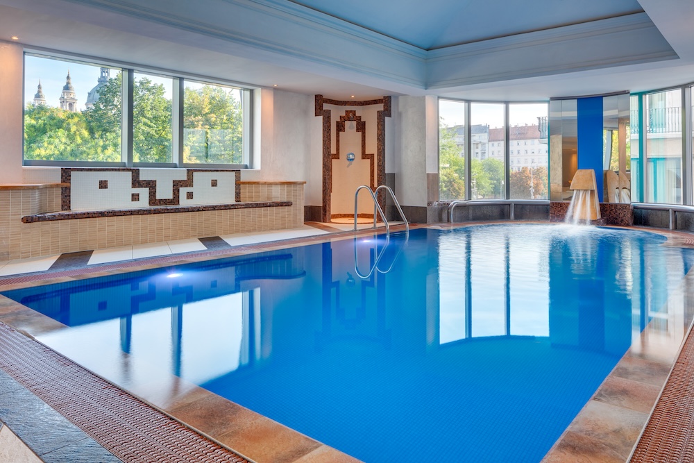 A swimming pool with water foundtains in a high end spa hotel