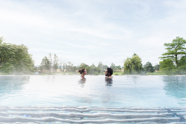 two people relaxing in a spa hydrothermal pool