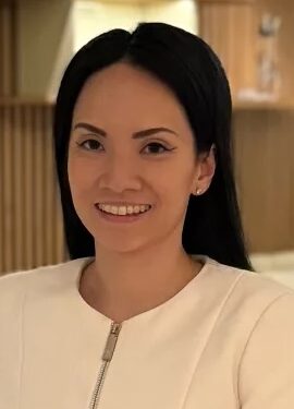 Smiling woman with hand on hip posing for a photo