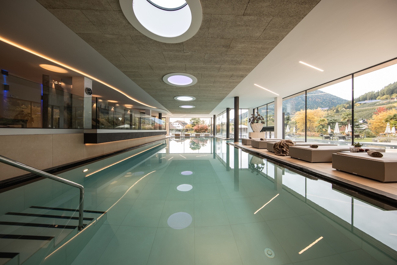 an indoor swimming pool area in a luxury hotel