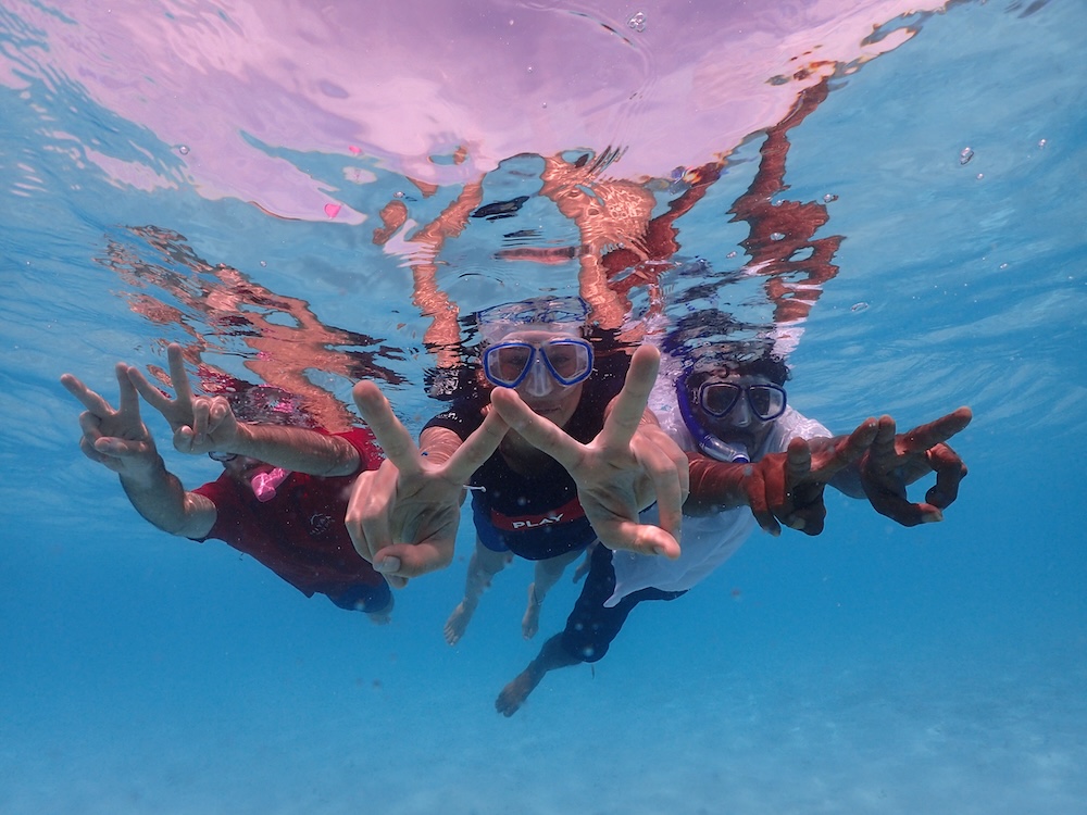 Underwater photo of someone making 'W' sign