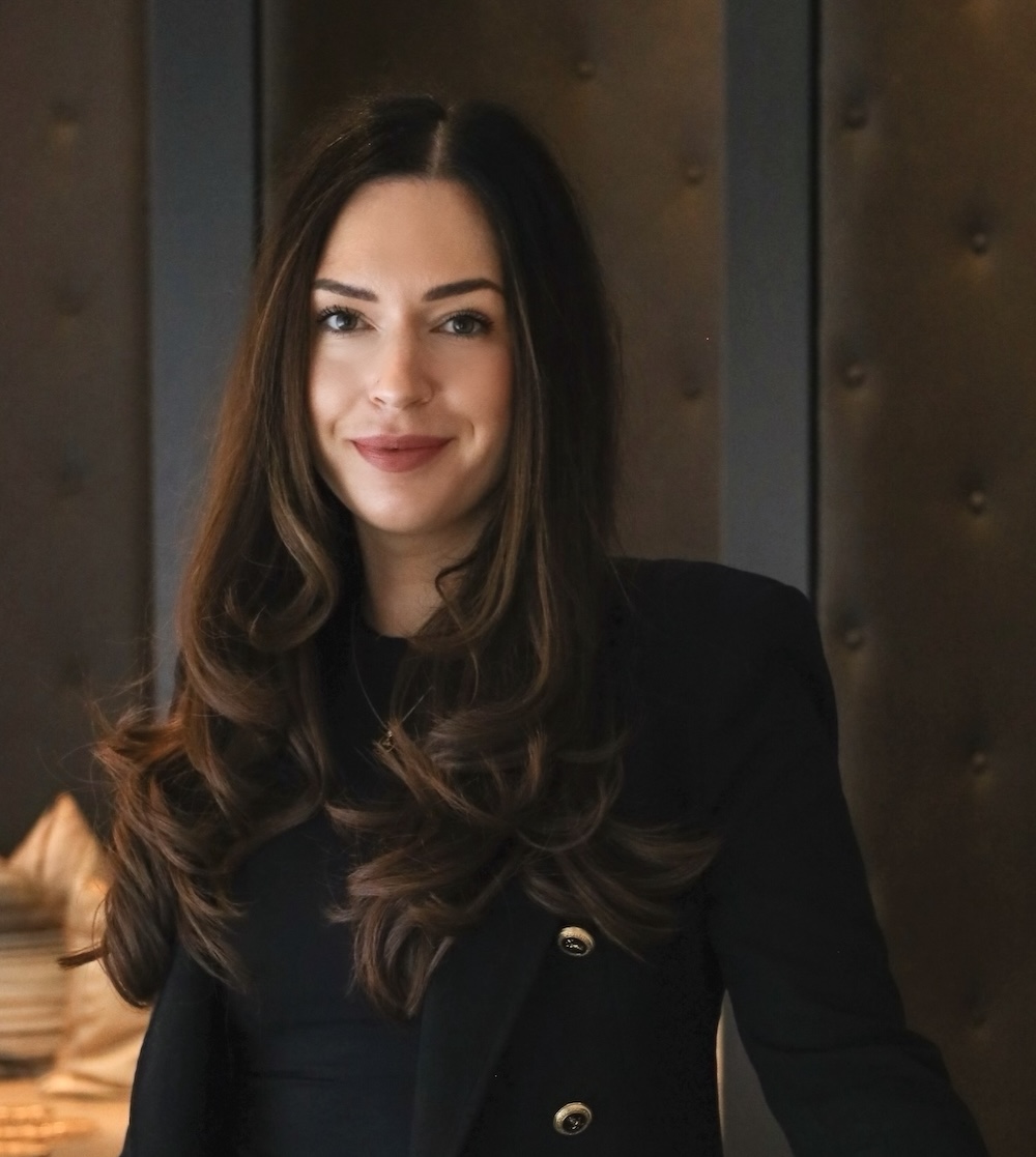 Dark haired woman in black jacket posing for the picture