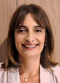 Headshot of smiling brunette with pink jacket
