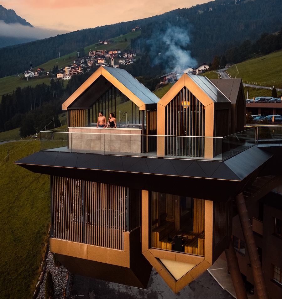 A couple stood in a mountain hotel overlooking the view