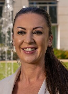 woman smiling wearing a smart jacket from Powerscourst Hotel Resort and Spa in Ireland