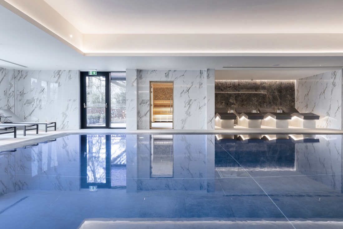 Indoor pool with loungers on one side