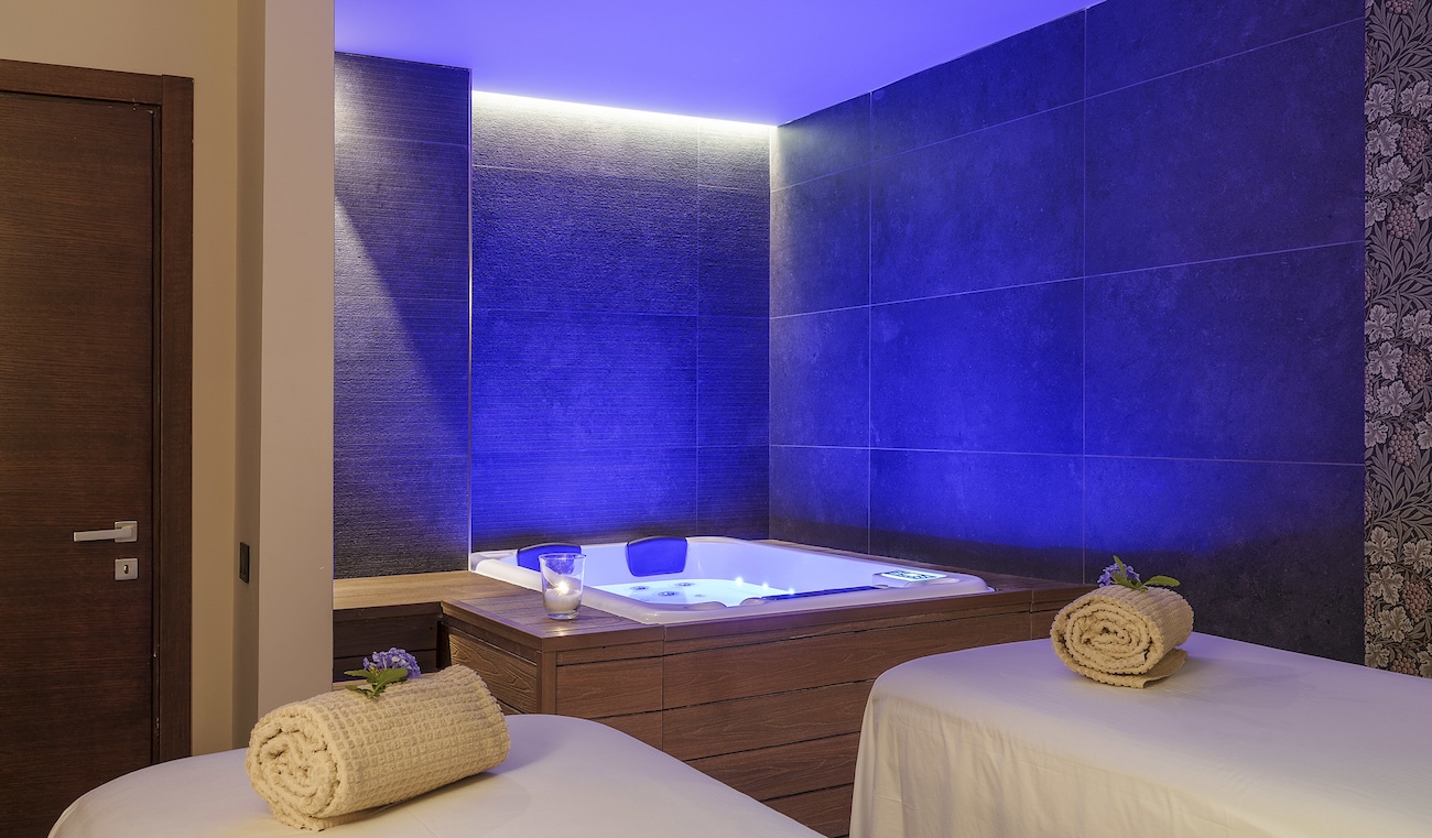 a double spa treatment room with a hot tub in the corner