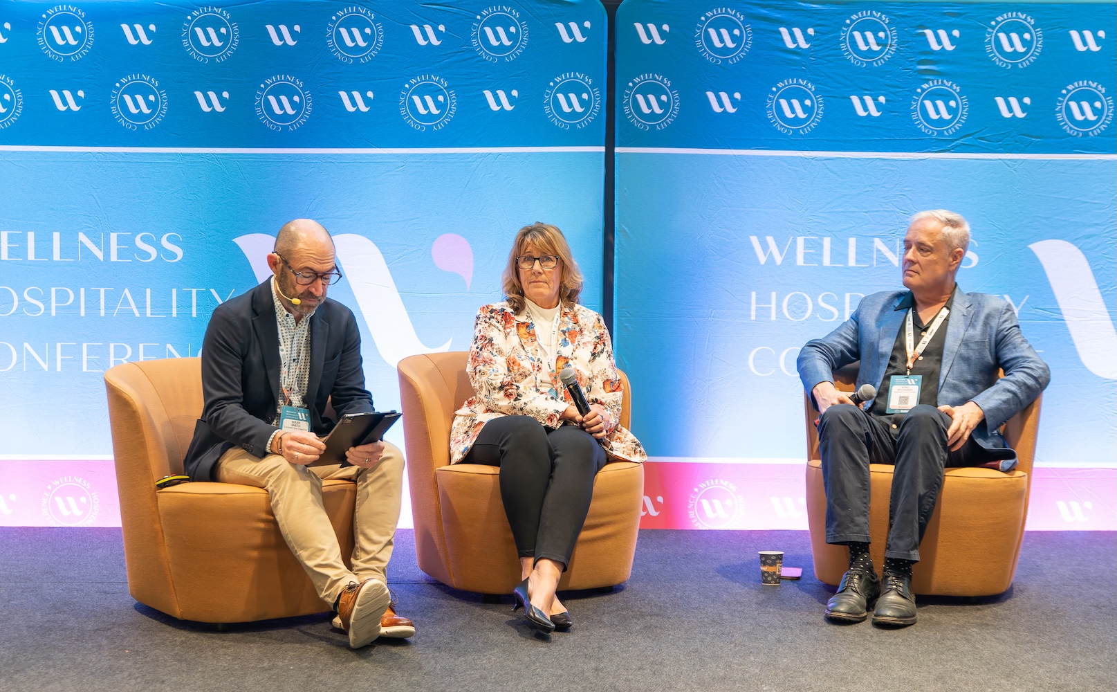 Three on stage at a conference