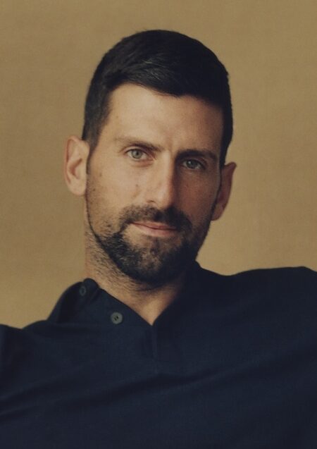 Novak Djokovic sat in a chair looking relaxed