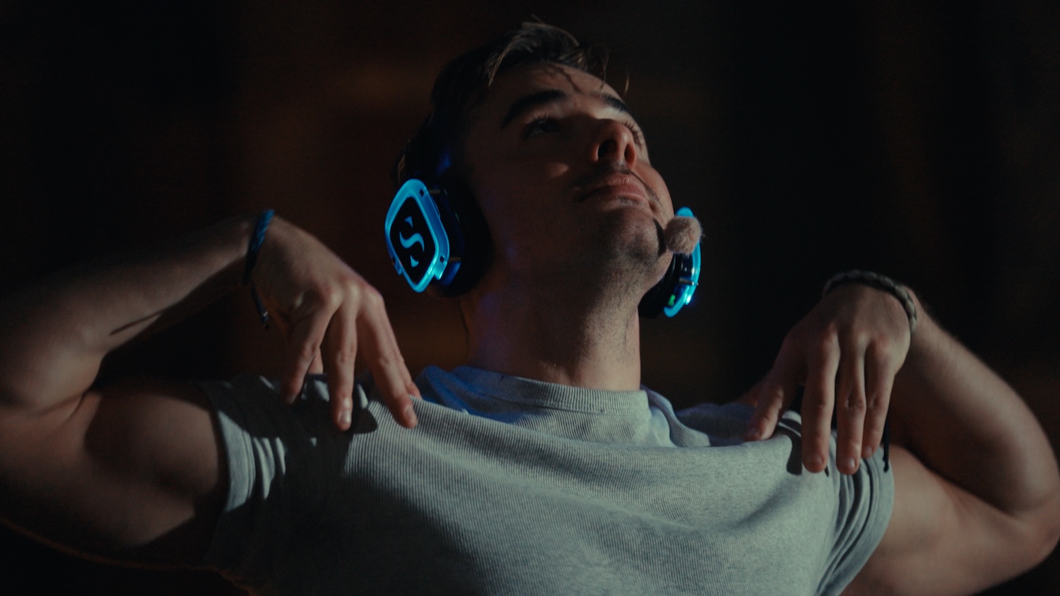 Man with head thrown back wearing headphones