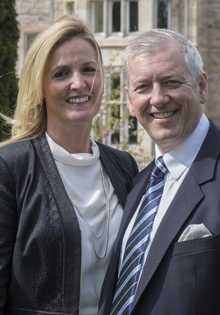 Man and woman posing in front of grand Scottish castle