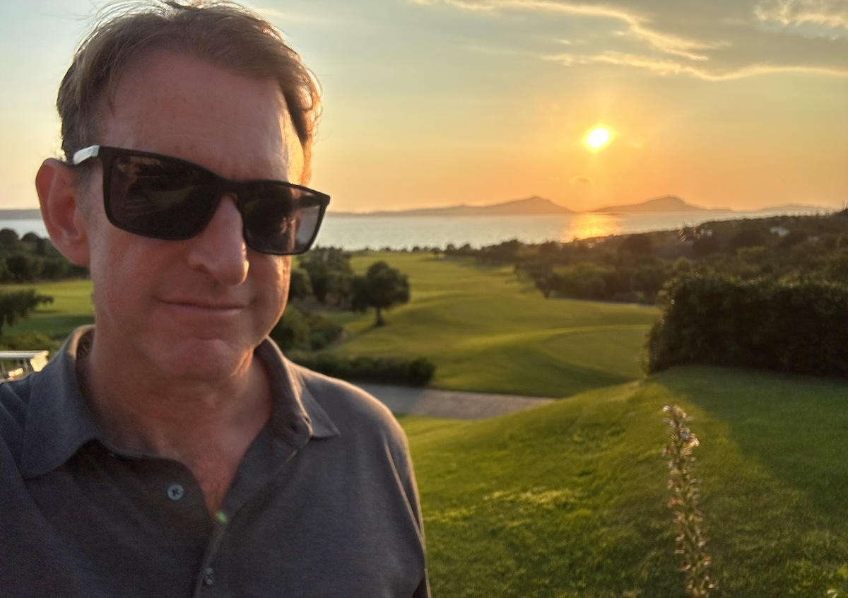 Up close selfie of a man with sunset view behind him