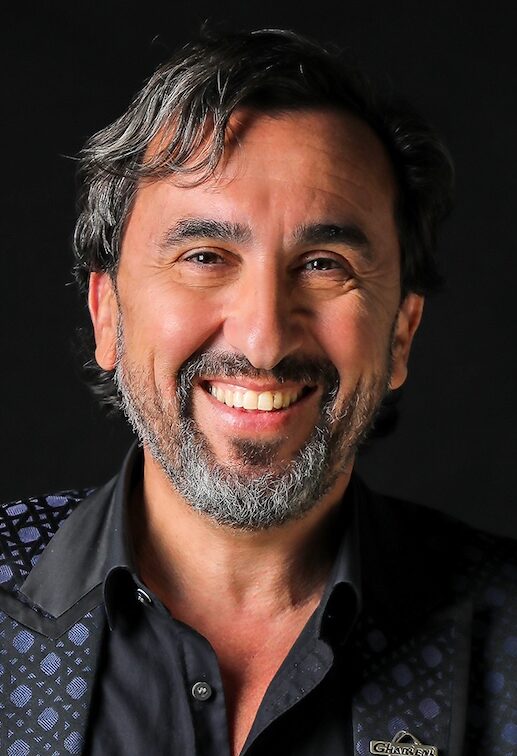 Headshot of man with beard in dark suit