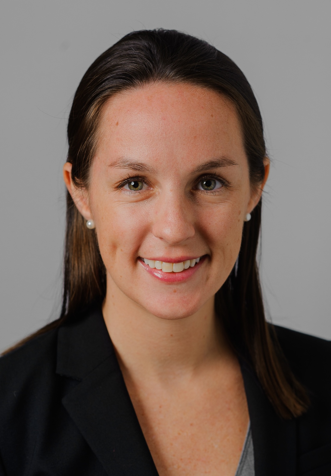 Headshot of smiling woman with dark straight hair