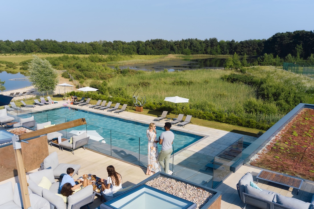 Render of a spa and swimming pool overlooking a lake and wetlands