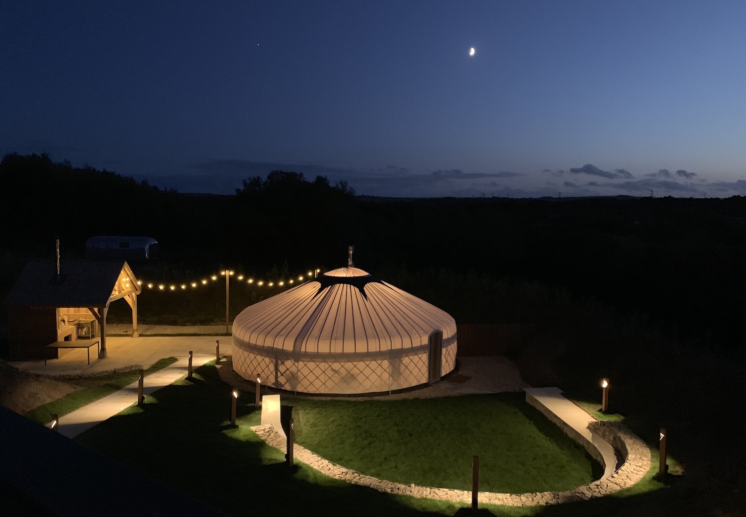 A yurt lit up from inside at night