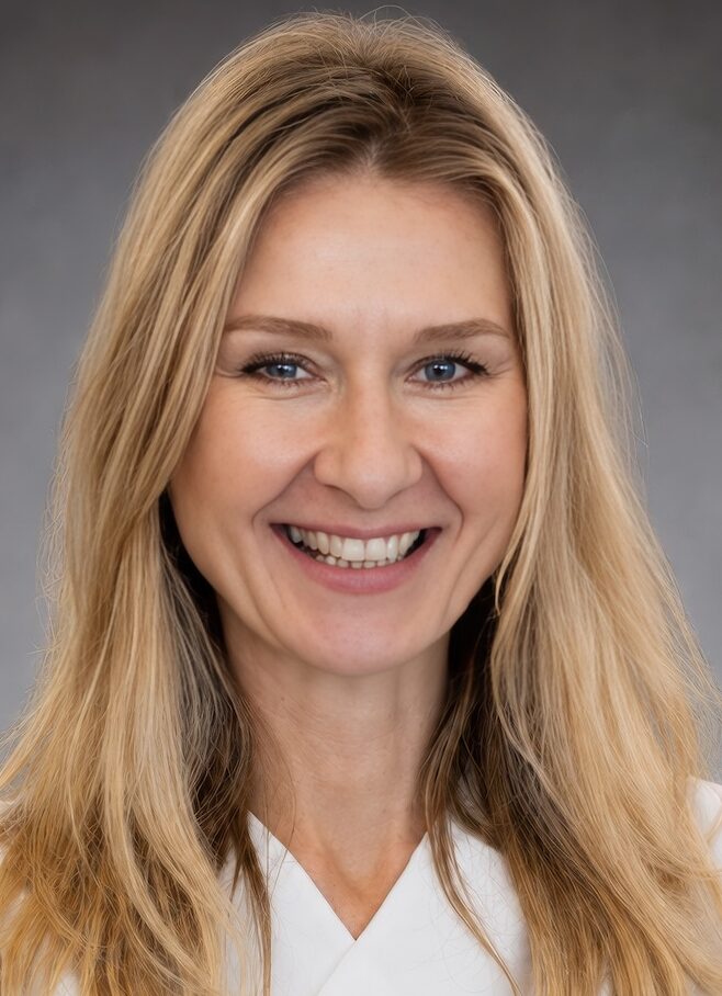 Smiling woman in white with long blonde hair