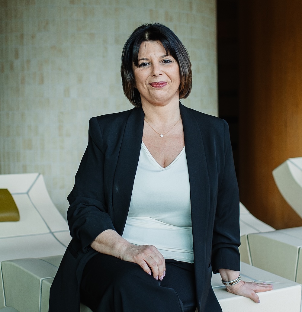 Dark-haired Woman sat on a ceramic lounger in a spa