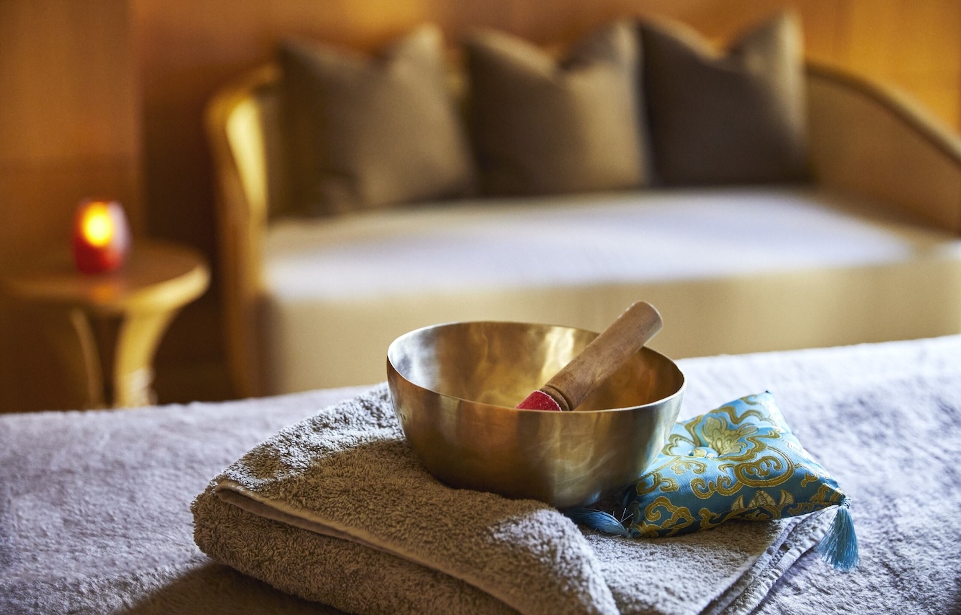Singing bowls laid on a spa treatment bed