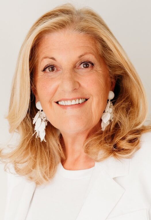 Woman wearing all white smiling for the camera
