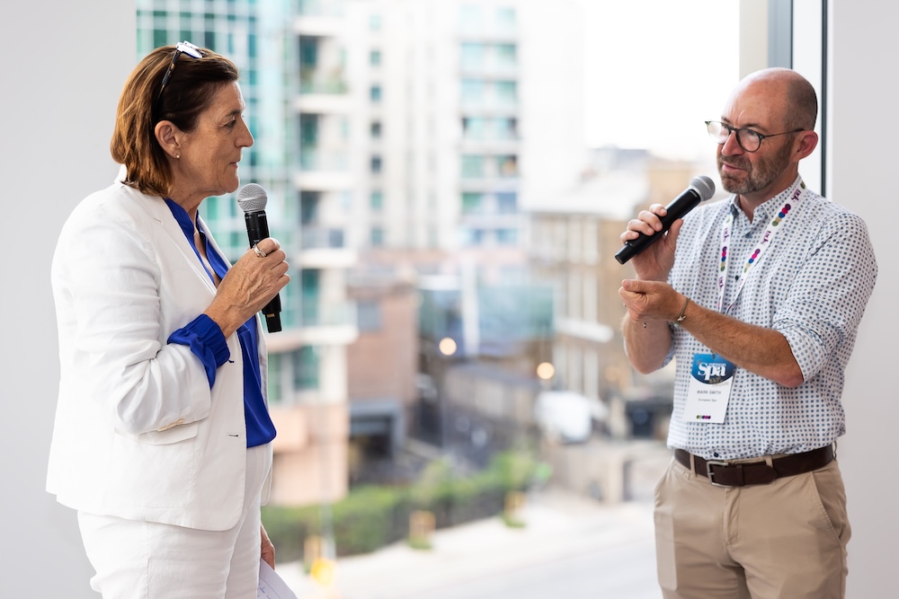 Man and women speaking into microphones
