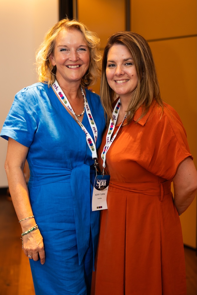 two women posing and smiling
