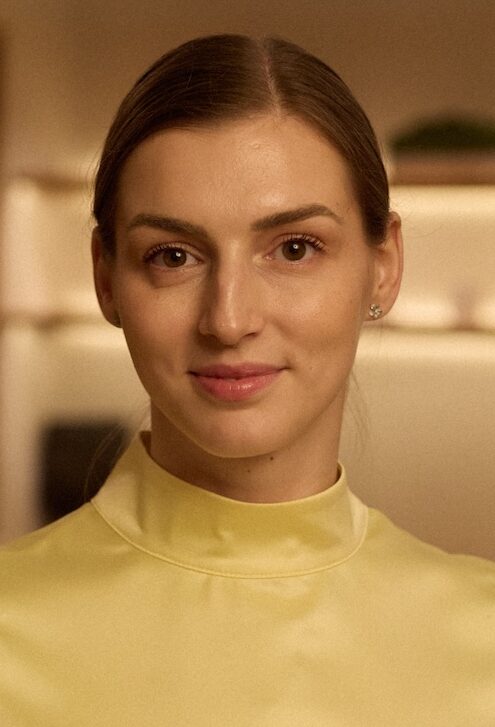 Woman in yellow silk top stood in a spa