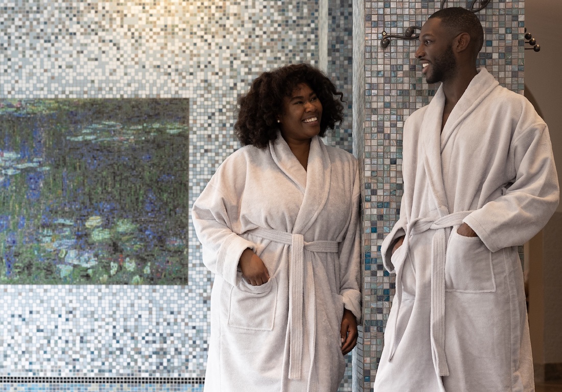 Two people in a spa wearing bathrobes
