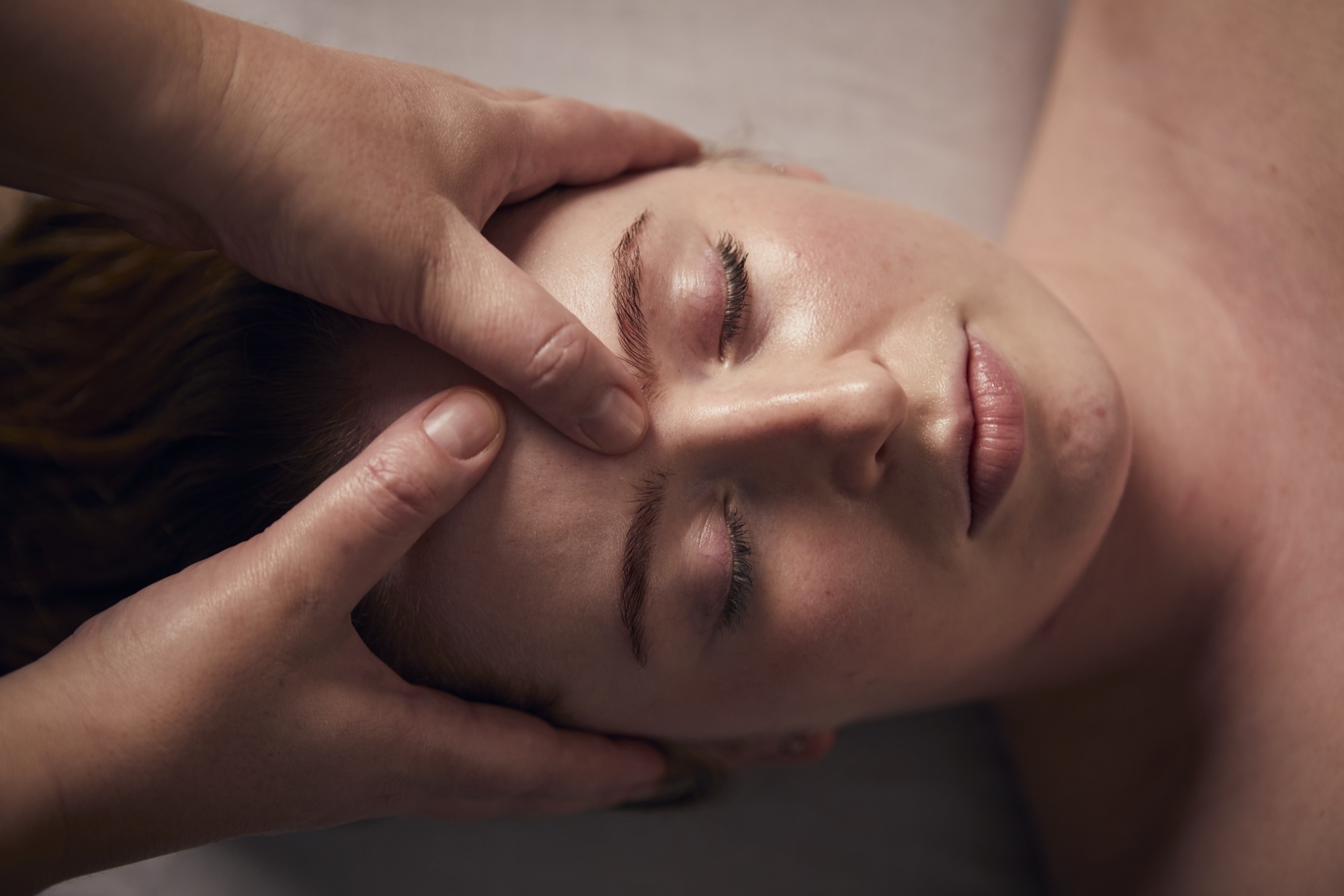 Woman having facial pressure point massage