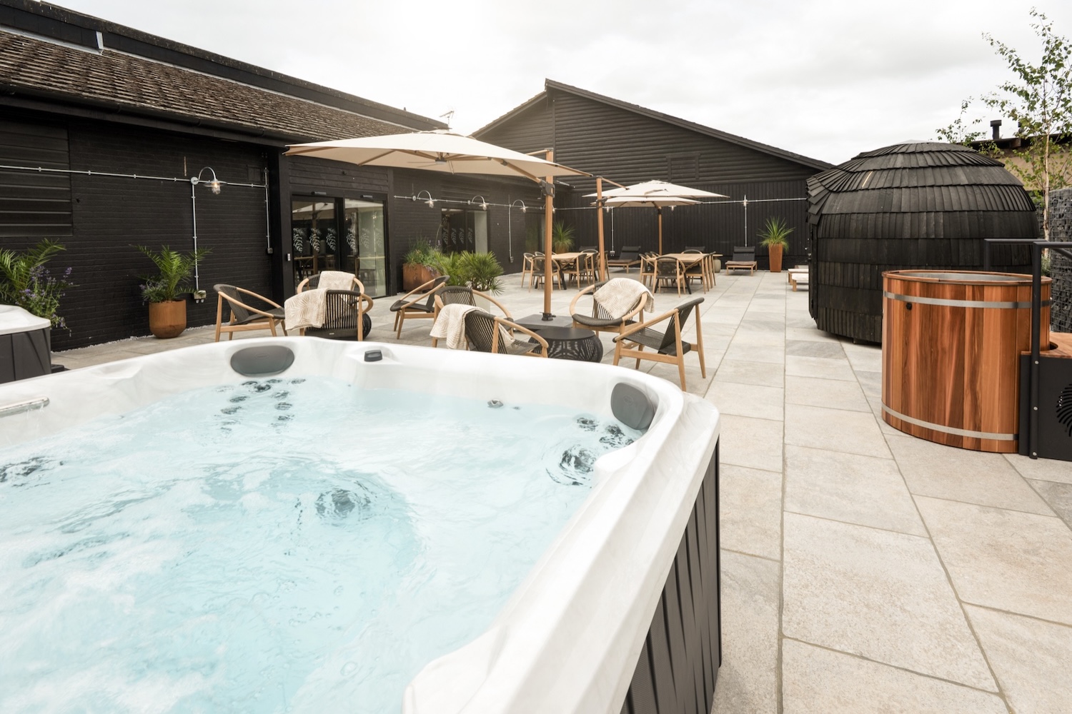 outdoor area of a spa with hot tub and sauna
