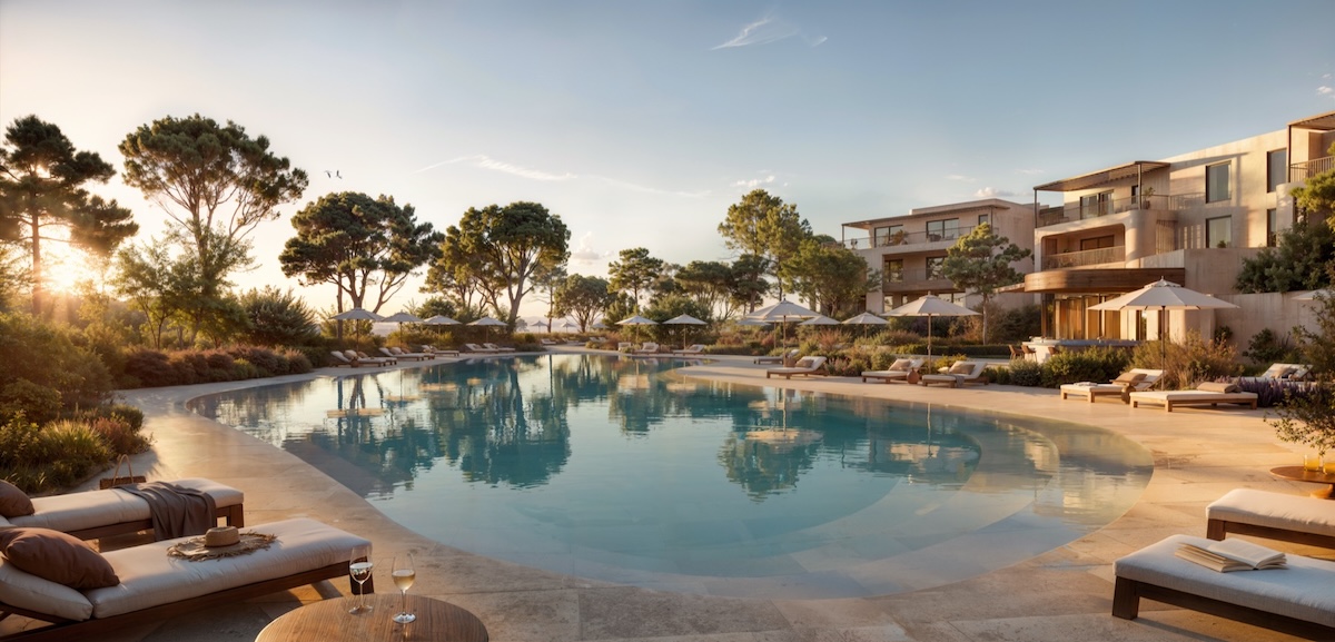 Large outdoor pool surrounded by loungers in the sunshine