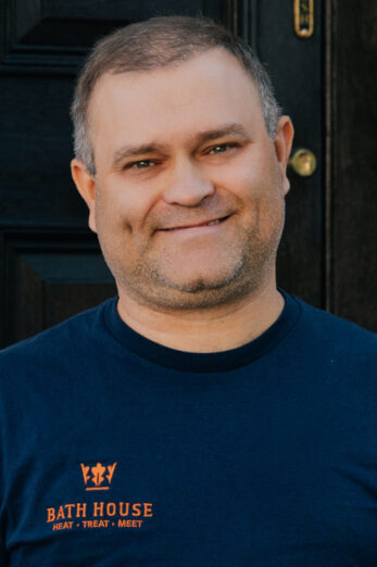 Man in blue t-shirt smiling for camera