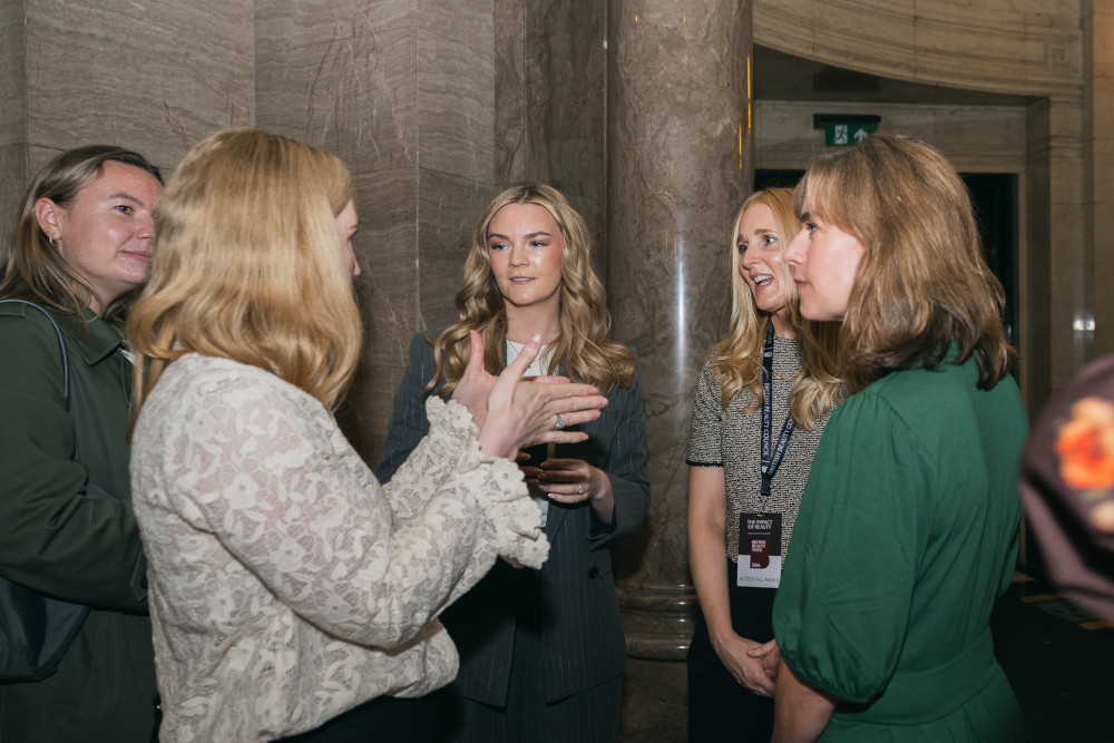 Women stood talking at a business event
