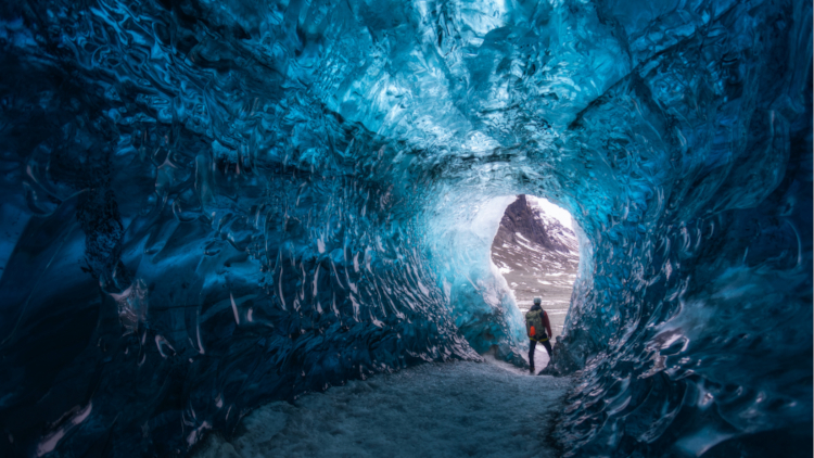 Man at the edge of an ice tunnel