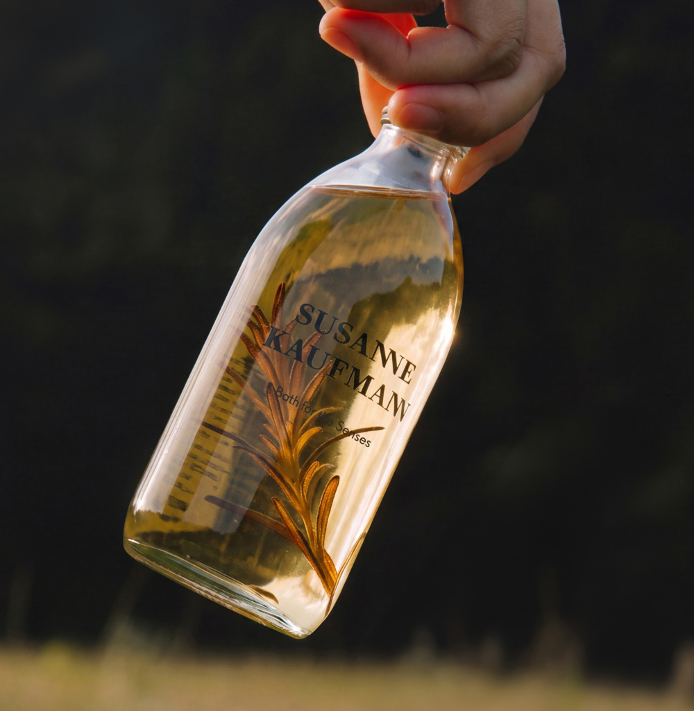 Oil filled bottle dangling from a hand