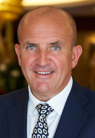 Bald man in blue suit with white shirt